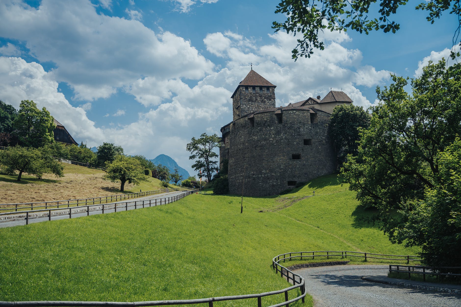 a vaduz castle near the green grass field